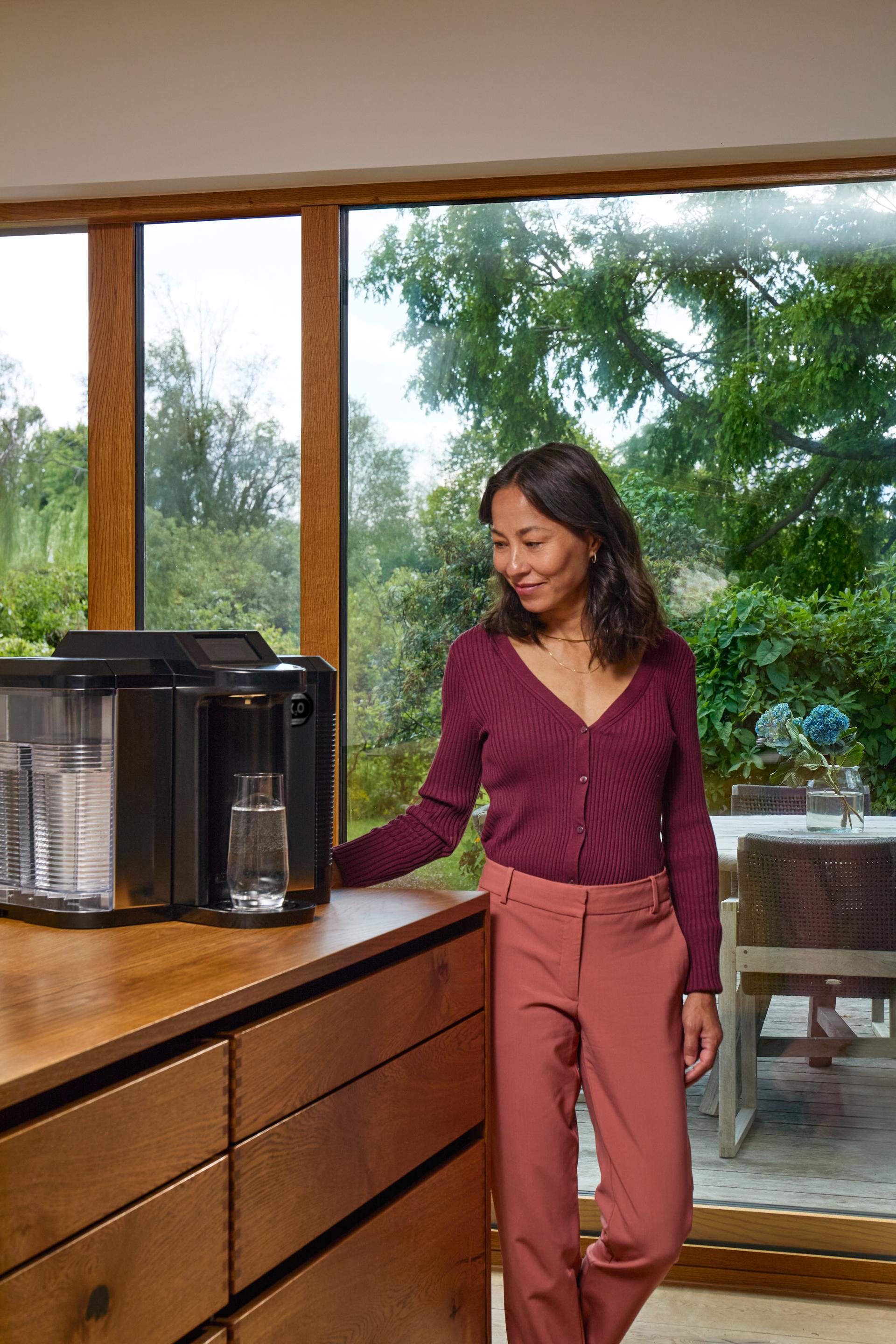 Woman at the X2O Water Machine, smiling